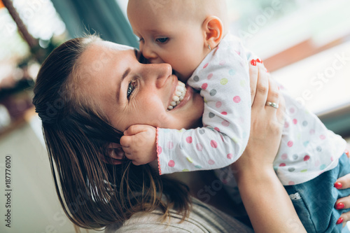 Foto Happy cheerful family. Mother and baby kissing and hugging