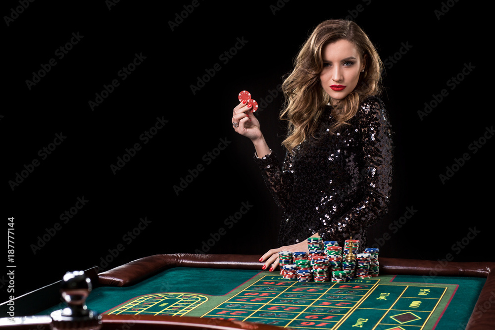 Woman playing in casino. Woman stakes piles of chips playing rou Woman playing in casino. Woman stakes piles of chips playing rou