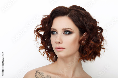 Close up beauty studio shot of beautiful redhead woman with gorgeous makeup curly hair