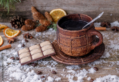 large coffee mug on a wooden table with snow
