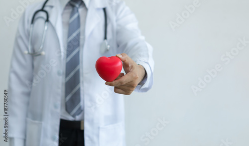 Doctor with stethoscope holding red heart represent to healtcare your heart