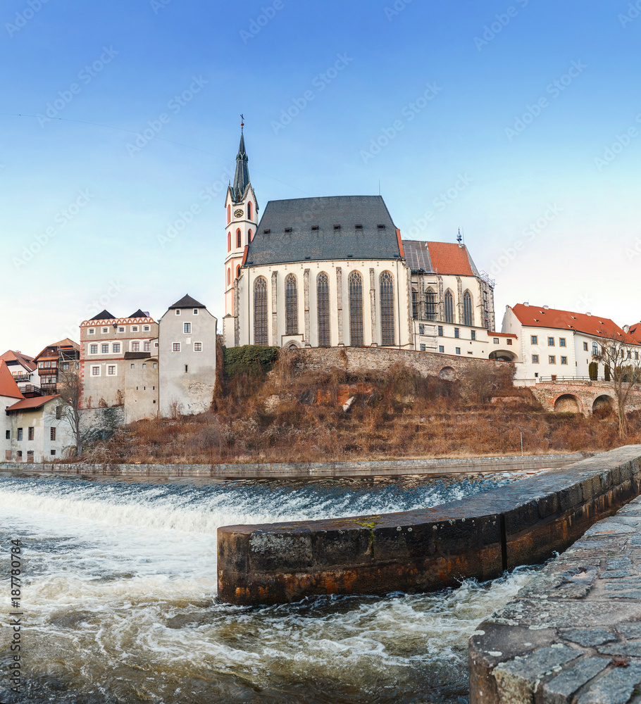 Fototapeta premium Church of St. Vitus on the banks of the Vltava in UNESCO Cesky Krumlov town