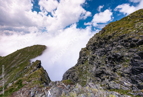 beautiful cloudscape over the cliffs of Fagarasan mountain ridge. lovely nature background on a summer day © Pellinni