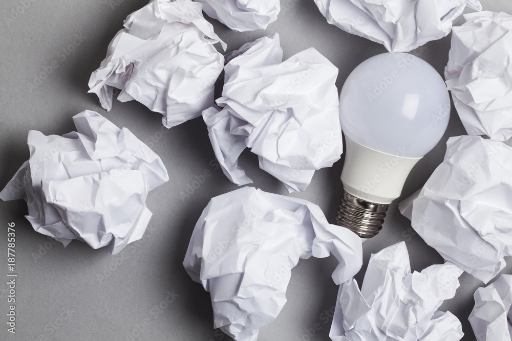 Inspiration and imagination concept. lightbulb with white crumpled ...