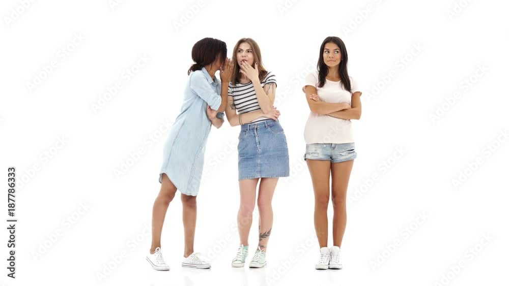Young serious shocked girls friends talking with each other and gossiping. Young serious shocked girls friends talking with each other and gossiping.