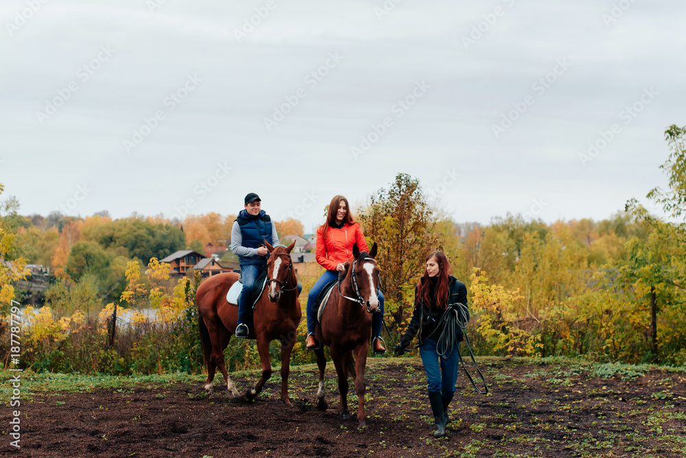 young couple in a Russian village with horses, riding young couple in a Russian village with horses, riding