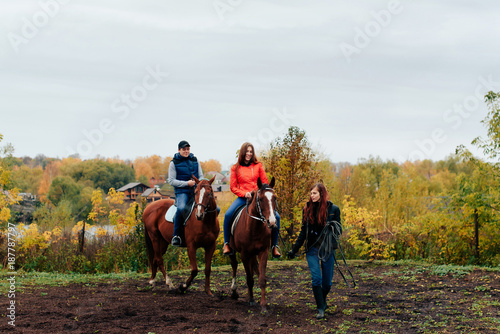 young couple in a Russian village with horses, riding