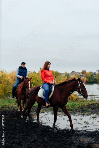 young couple in a Russian village with horses, riding © ShevarevAlex