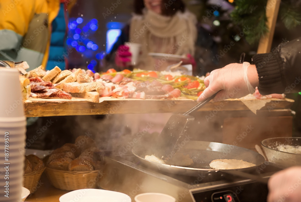cooking food in the winter outside. A party cooking food in the winter outside. A party