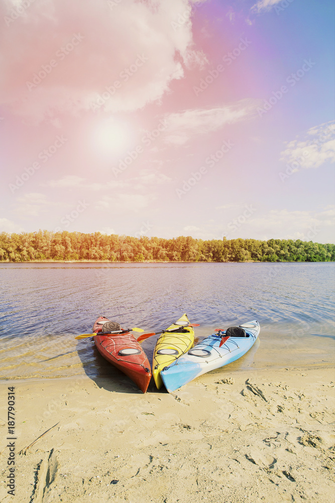 Kayaking on the Lake Concept Photo. Sport Kayak on the Rocky Lake Shore. Close Up Photo. Kayaking on the Lake Concept Photo. Sport Kayak on the Rocky Lake Shore. Close Up Photo.