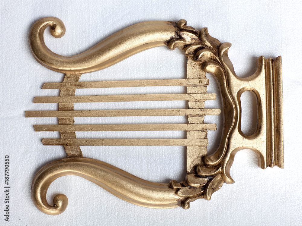 Gold colour antique mouth harp, white background Stock Photo Adobe Stock