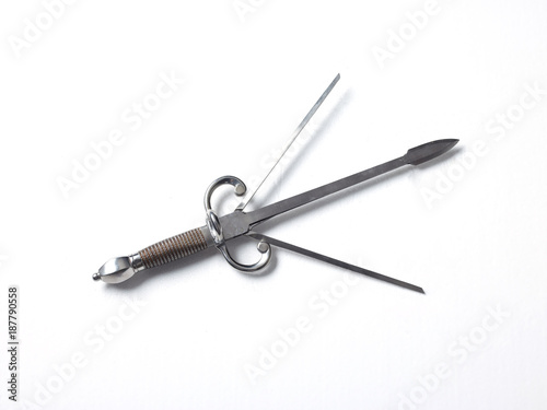 Silver colour three pronged dagger, white background  photo