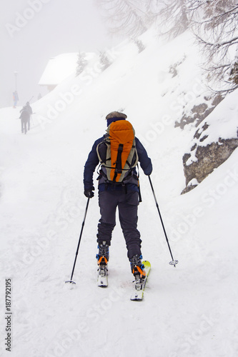 Man with skis walk by snow on the mountain