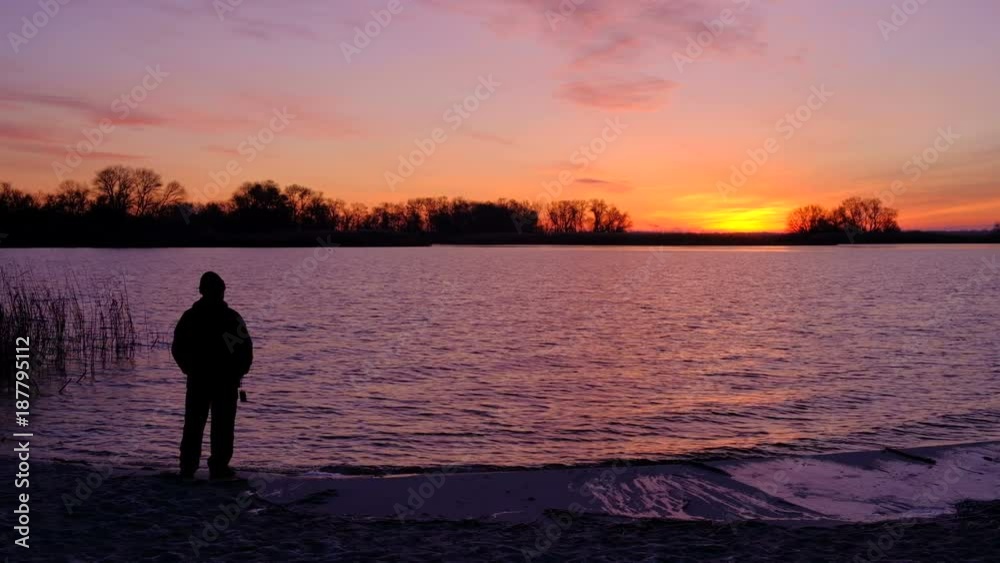 Old Man admiring sunrise on the beach. Beautiful colorful fiery sunset. Old Man admiring sunrise on the beach. Beautiful colorful fiery sunset.