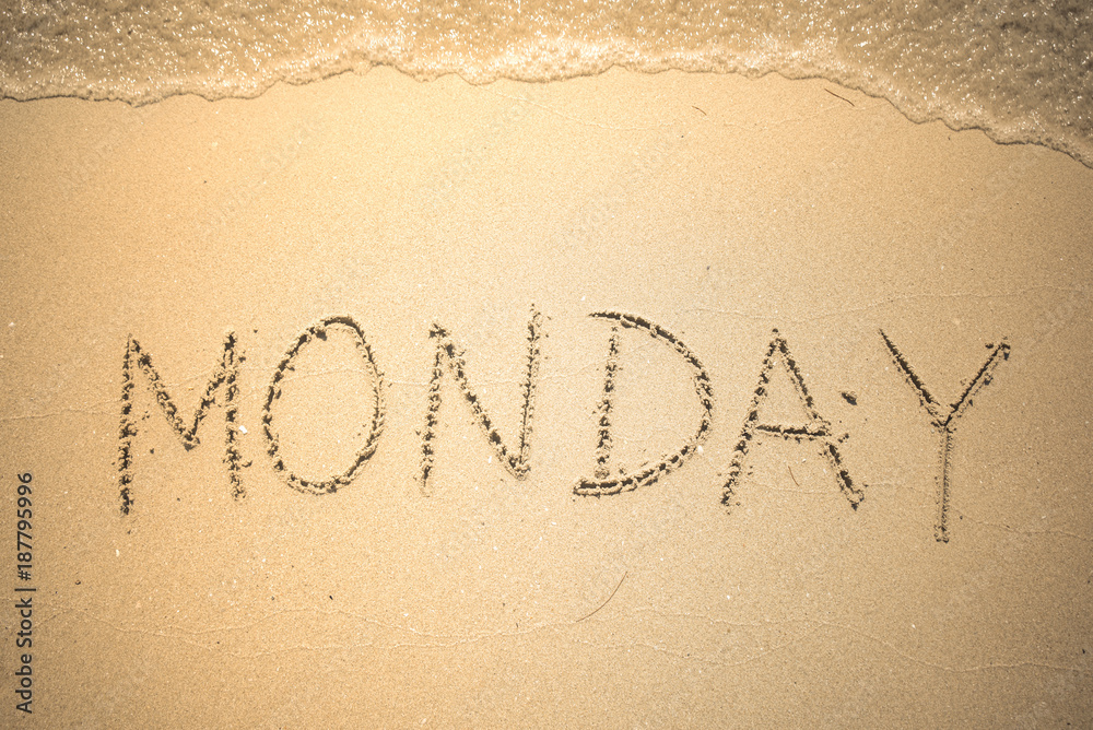 Fototapeta premium Monday word is written on the beach sand