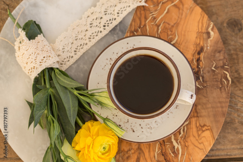 Cup of black coffee and flowers photo