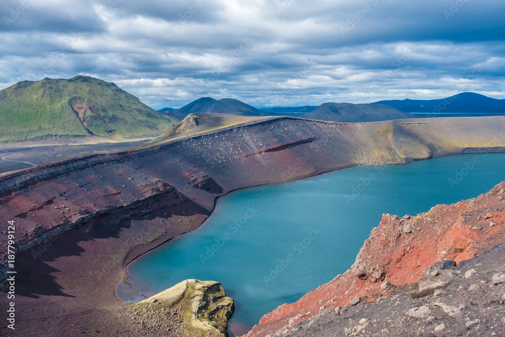 Ljotipollur Crater Lake amid stunning landscapes of Landmannalaugar in the Fjallabak Nature Reserve at the edge of the Laugahraun lava field in the Highlands of Iceland.