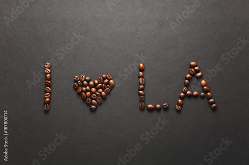 Top view of I love Los Angeles letter - I heart LA words made from coffee beans on black background for design. USA card on America, country state concept. Copy space for advertisement. photo