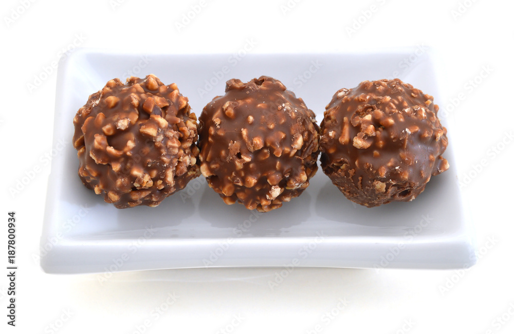 Chocolate candies isolated in white plate on white background cutout Chocolate candies isolated in white plate on white background cutout