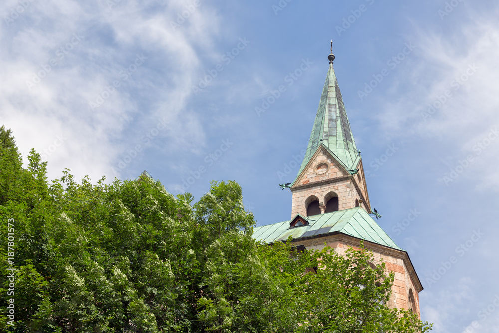 silhouette of church with tower against mountain slope with trees in Berchtesgaden, Germany silhouette of church with tower against mountain slope with trees in Berchtesgaden, Germany