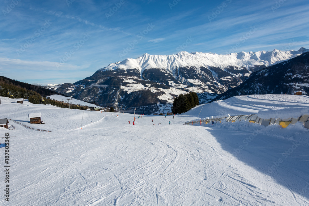 Slope and yellow gondolas in ski resort Serfaus Fiss Ladis in Austria with snowy mountains