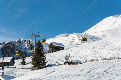 Yellow gondolas in ski resort Serfaus Fiss Ladis in Austria with snowy mountains