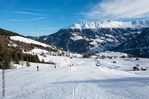 Slope and yellow gondolas in ski resort Serfaus Fiss Ladis in Austria with snowy mountains