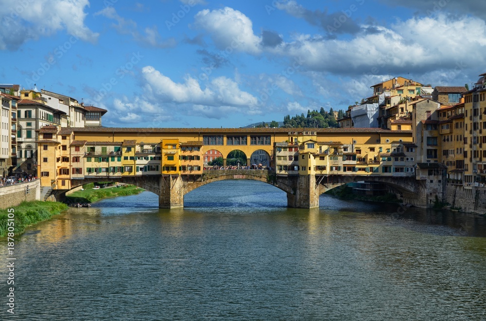 Florence, Pontevecchio, Tuscany, Italy August 27, 2014 Arno river. Blue sky with soft white summer clouds.