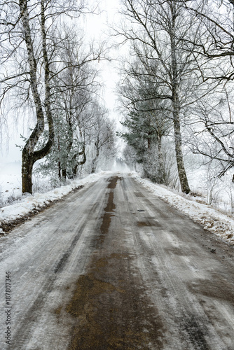 car tire tracks on winter road © Martins Vanags