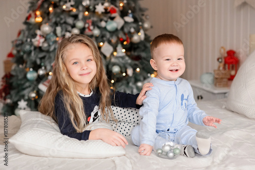 Merry Christmas celebration. Beautiful kids near the Christmas tree. Christmas miracles. Happy New Year