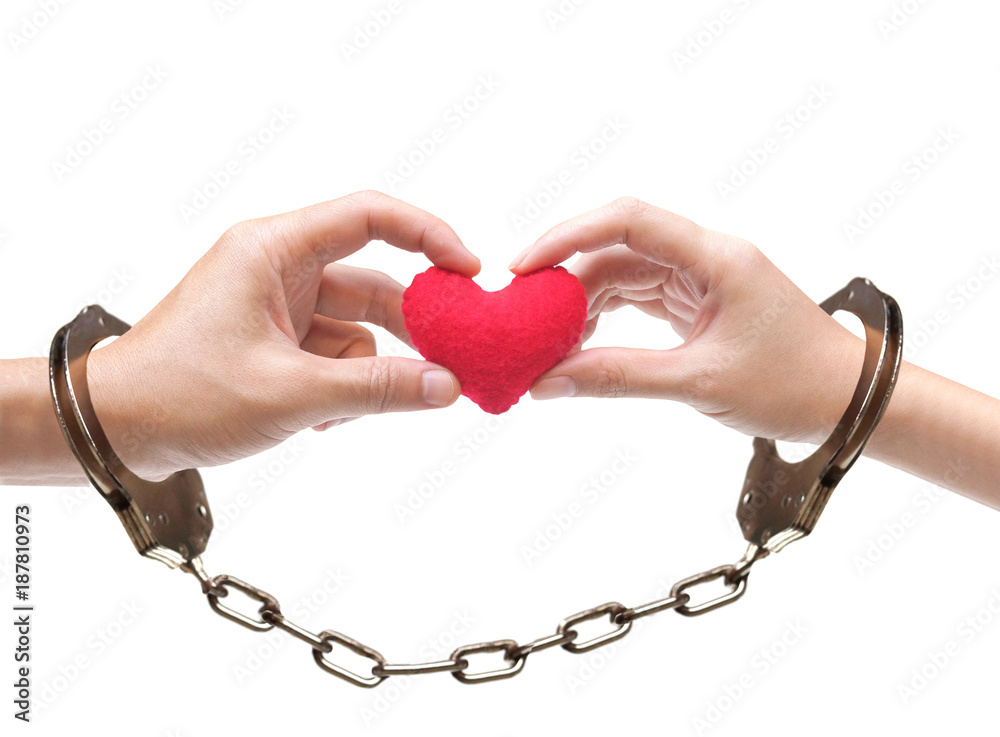 A couple' hands holding as a red heart together with hand cuffs / Love and  romance on Valentine's day concept Stock Photo | Adobe Stock