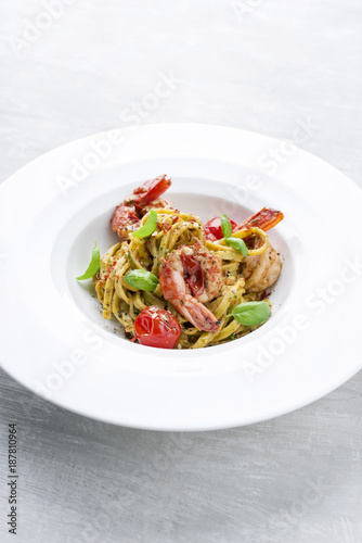 Traditional Italian tagliatelle ai gamberoni with tomatoes as close-up on a plate