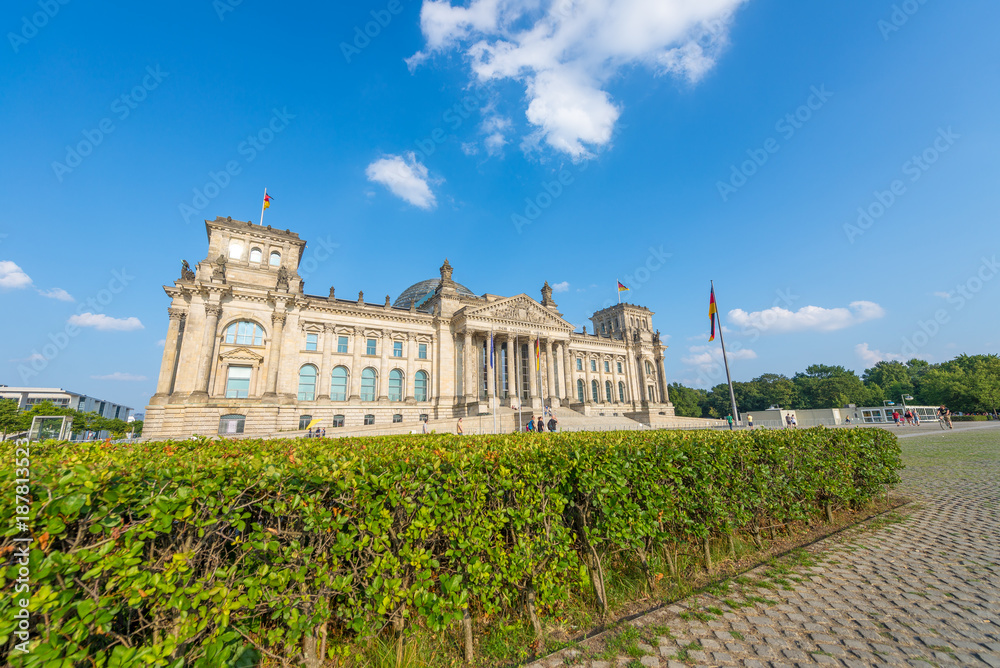 BERLIN, GERMANY - JULY 24, 2016: Beautiful view of Reichstag surrounded by gardens. Berlin attracts 20 million people annually