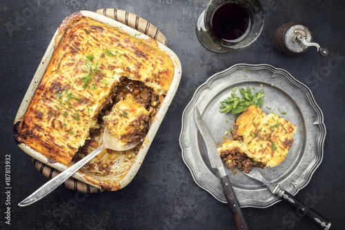 English shepherds pie as top-view on a pewter plate and backing dish photo