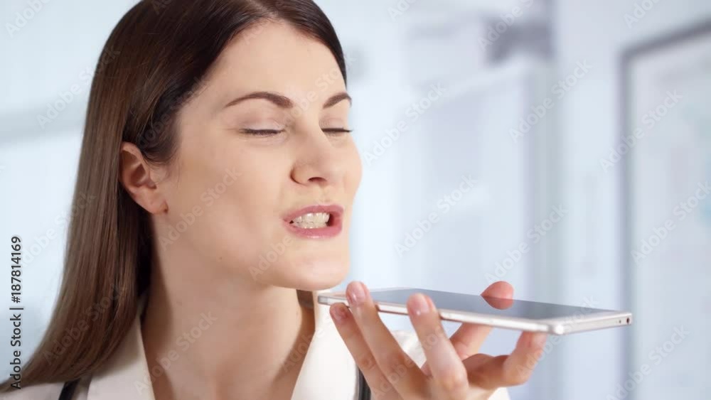 Portrait of smiling confident professional female doctor with stethoscope standing in hospital room talking on phone with patient. Woman physician at work. Health care concept Portrait of smiling confident professional female doctor with stethoscope standing in hospital room talking on phone with patient. Woman physician at work. Health care concept