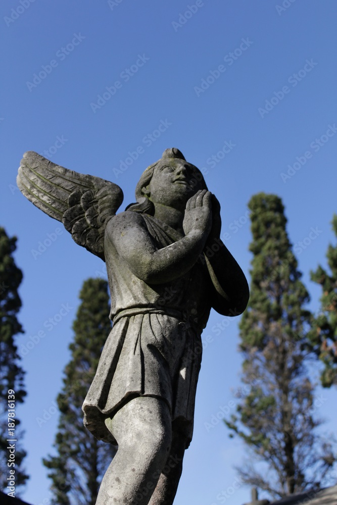Stone statue in a lonely cemetery Stone statue in a lonely cemetery