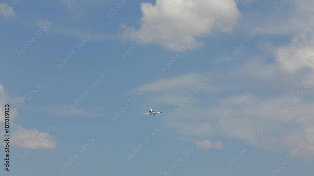 the plane flies across the sky under the clouds the plane flies across the sky under the clouds