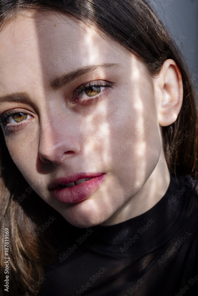 Shadow on face of serious Caucasian woman Shadow on face of serious Caucasian woman