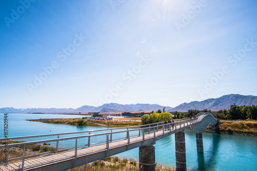 Beautiful scene of Mt Cook and walk bridge to Church of the Good Shepherd beside the lake with blue sky, at the village, New Zealand