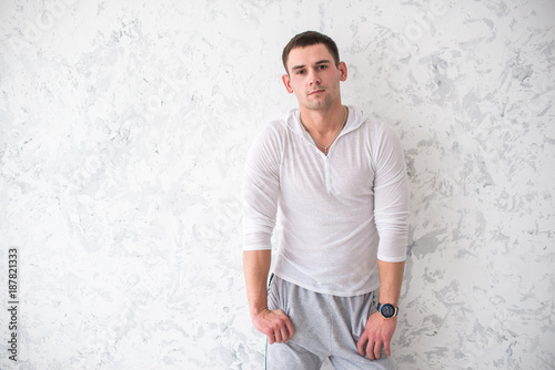 Handsome young man in sportswear on a white background, model photo. photo