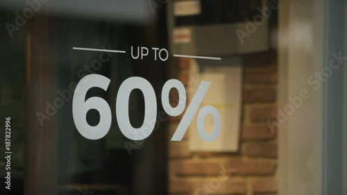 Sale sign showing a discount of goods in a shop window