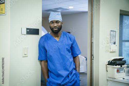 Portrait of a black nurse leaning in doorway