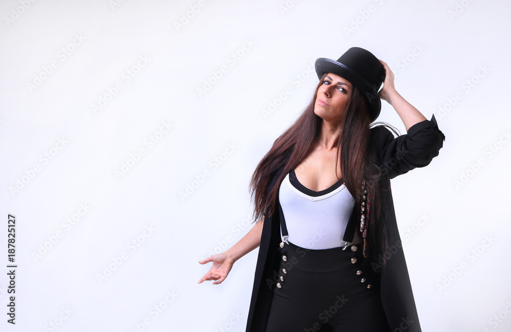 woman wearing a white tee shirt, suspenders and black bowler top hat woman wearing a white tee shirt, suspenders and black bowler top hat