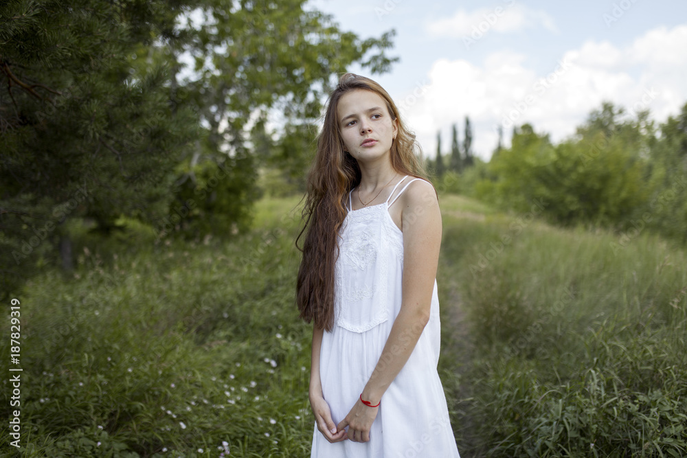 Pensive Caucasian girl standing in field Pensive Caucasian girl standing in field