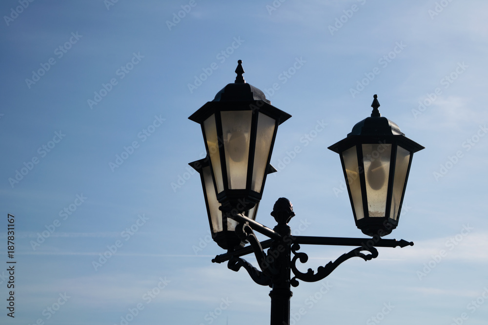 Street light against the blue sky