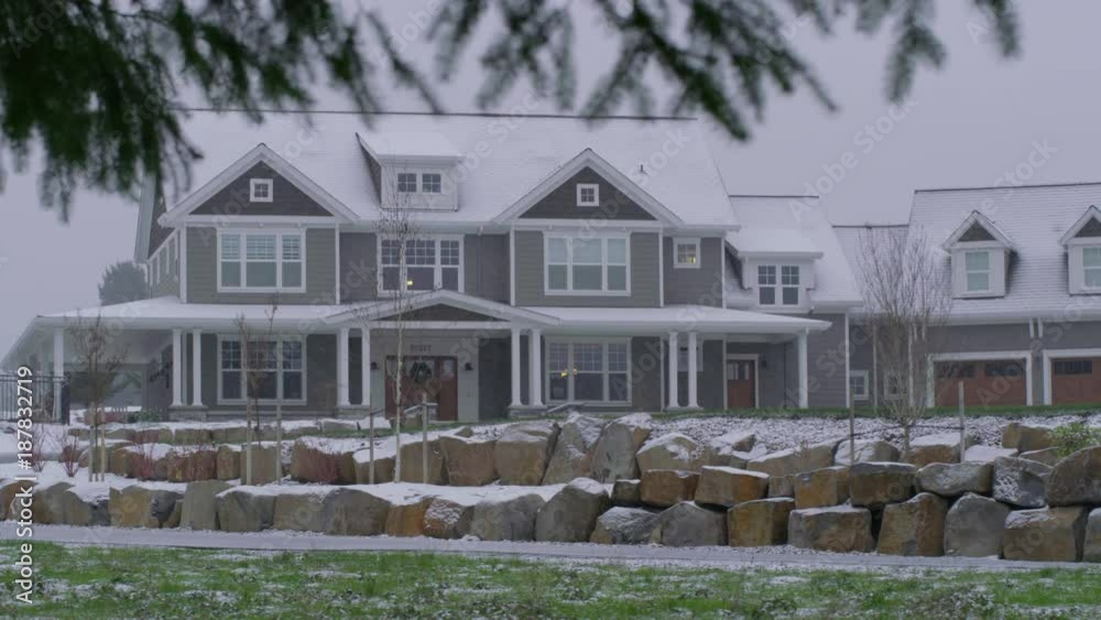 Country home in winter storm with snow falling