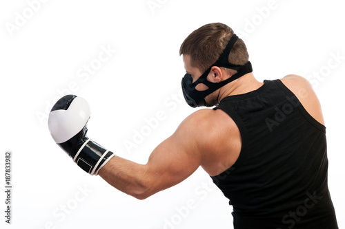 Photos A young athletic man in a sports T-shirt, training black mask, boxing gloves per