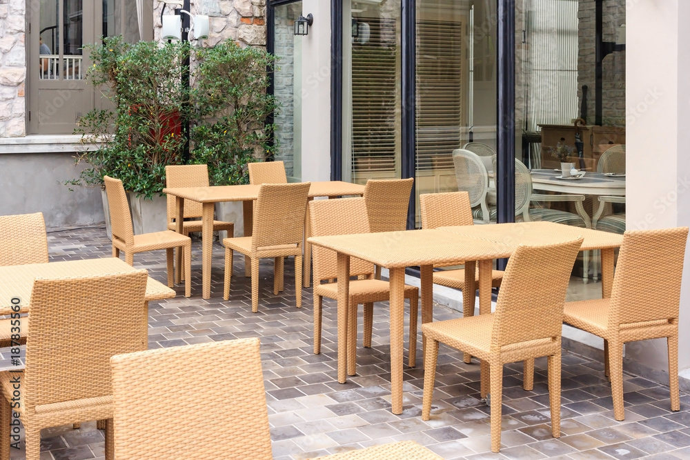 Outdoor cafe tables and chairs with window reflection outside view with vintage color tone