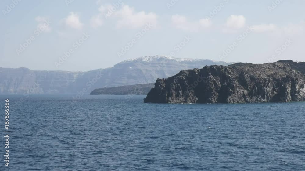the village of thira on santorini in greece, as seen from a ferry boat the village of thira on santorini in greece, as seen from a ferry boat