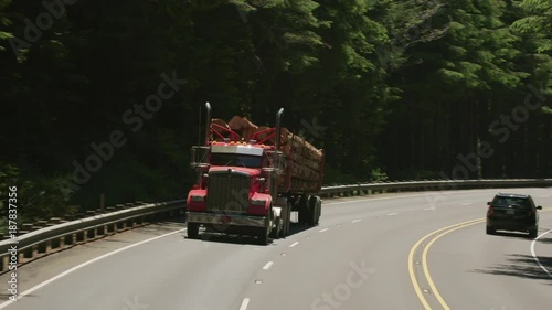 Oregon circa-2107, Logging truck driving on highway in Oregon forest.